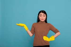 sad-frustrated-tired-asian-homeworker-from-chores-pointing-hand-aside-copy-space-wearing-yellow-gloves-cleaning-home-concept-unhappy-stressed-woman-negative-state-mind