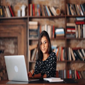 young-woman-glasses-works-laptop-while-sitting-table