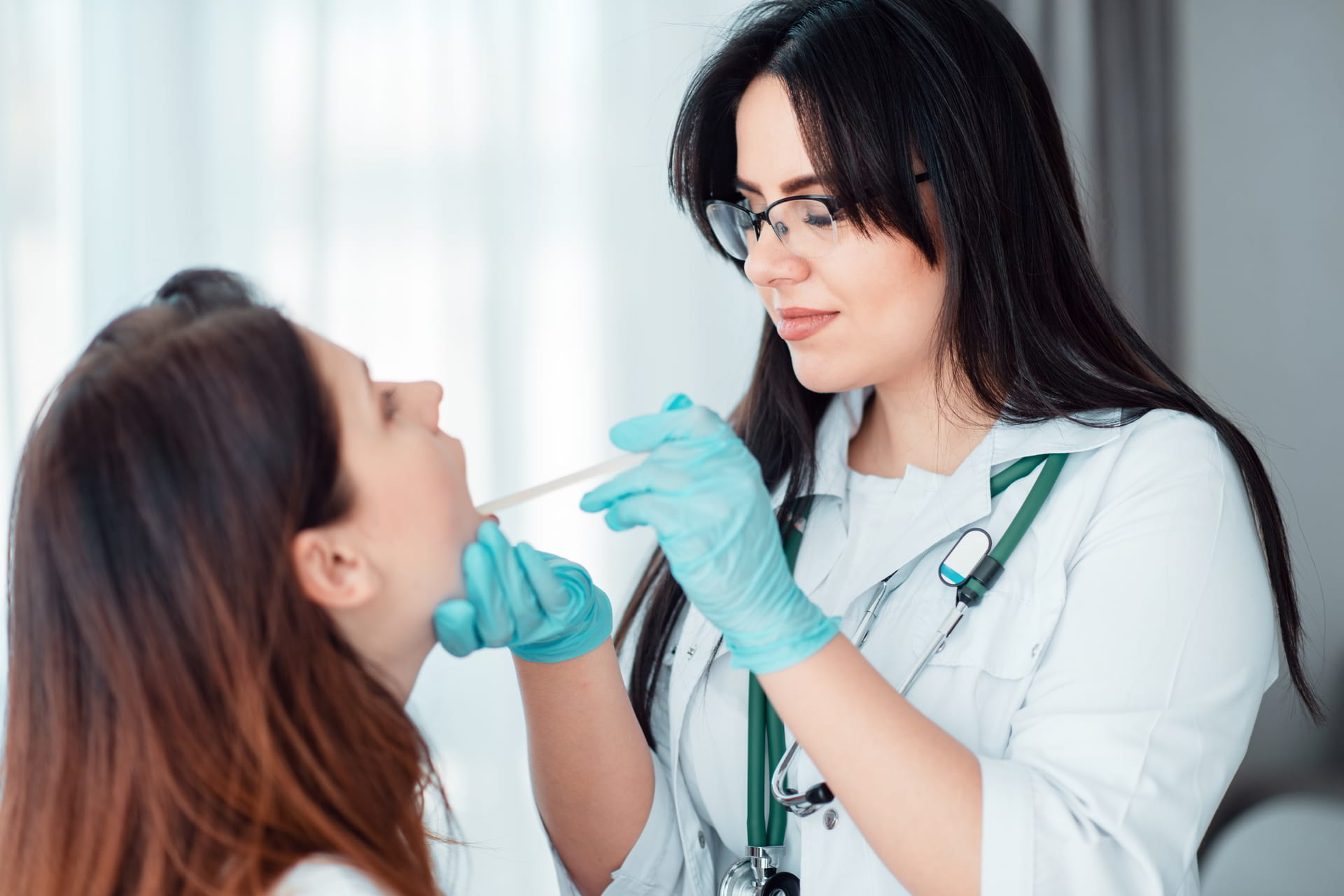 family doctor looking in mouth